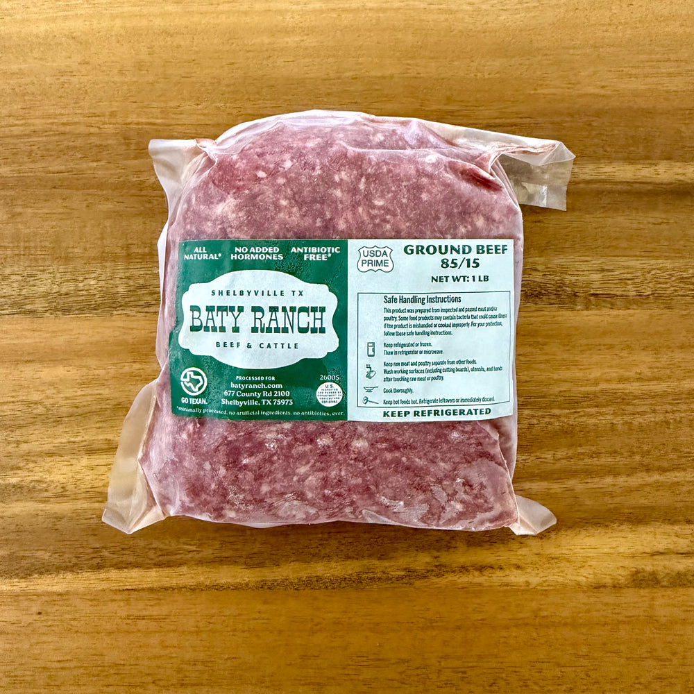 Packaged ground beef with a label on a wooden surface
