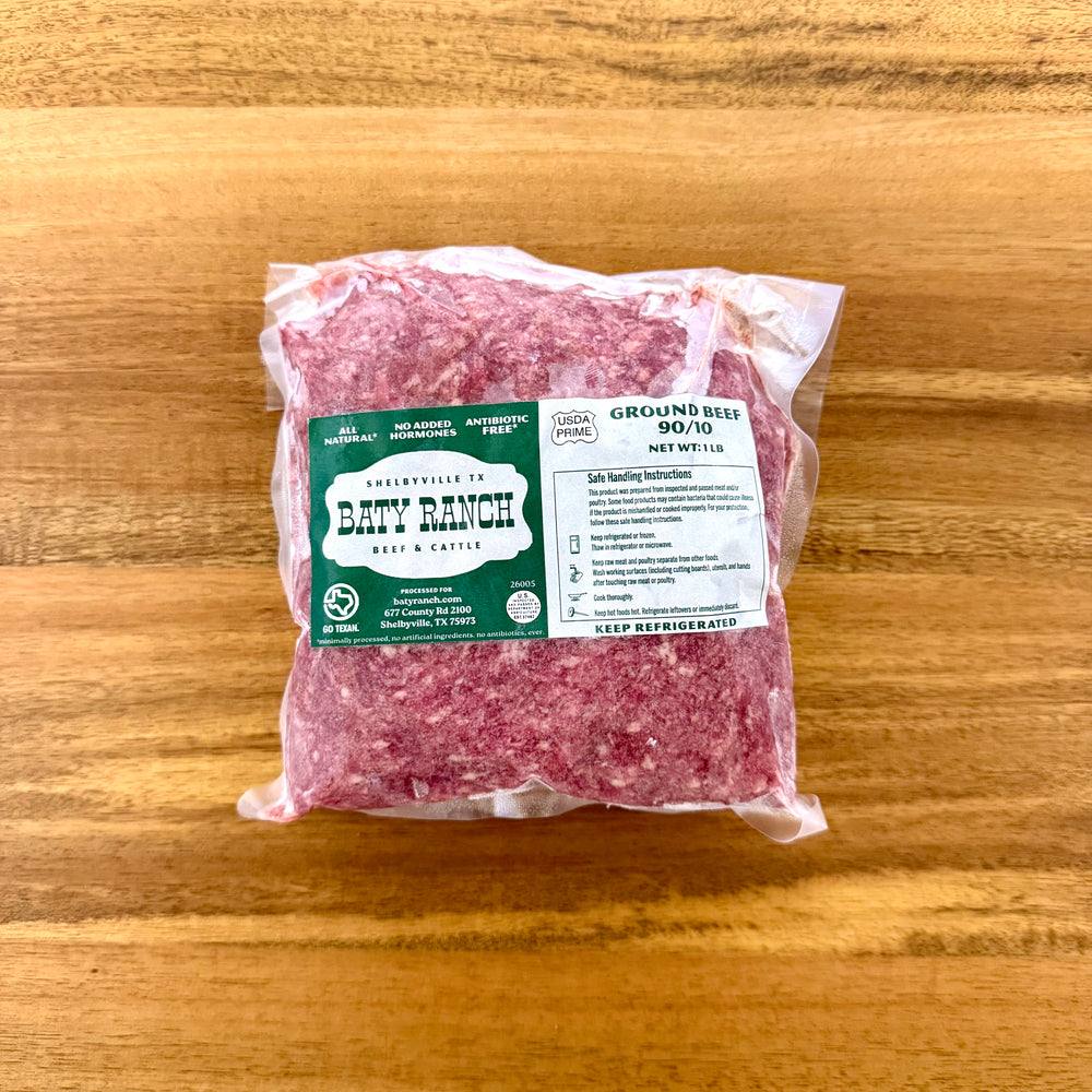 Packaged ground beef with a label on a wooden surface
