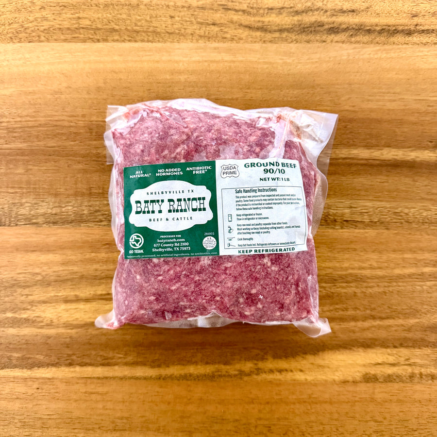 Packaged ground beef with a label on a wooden surface