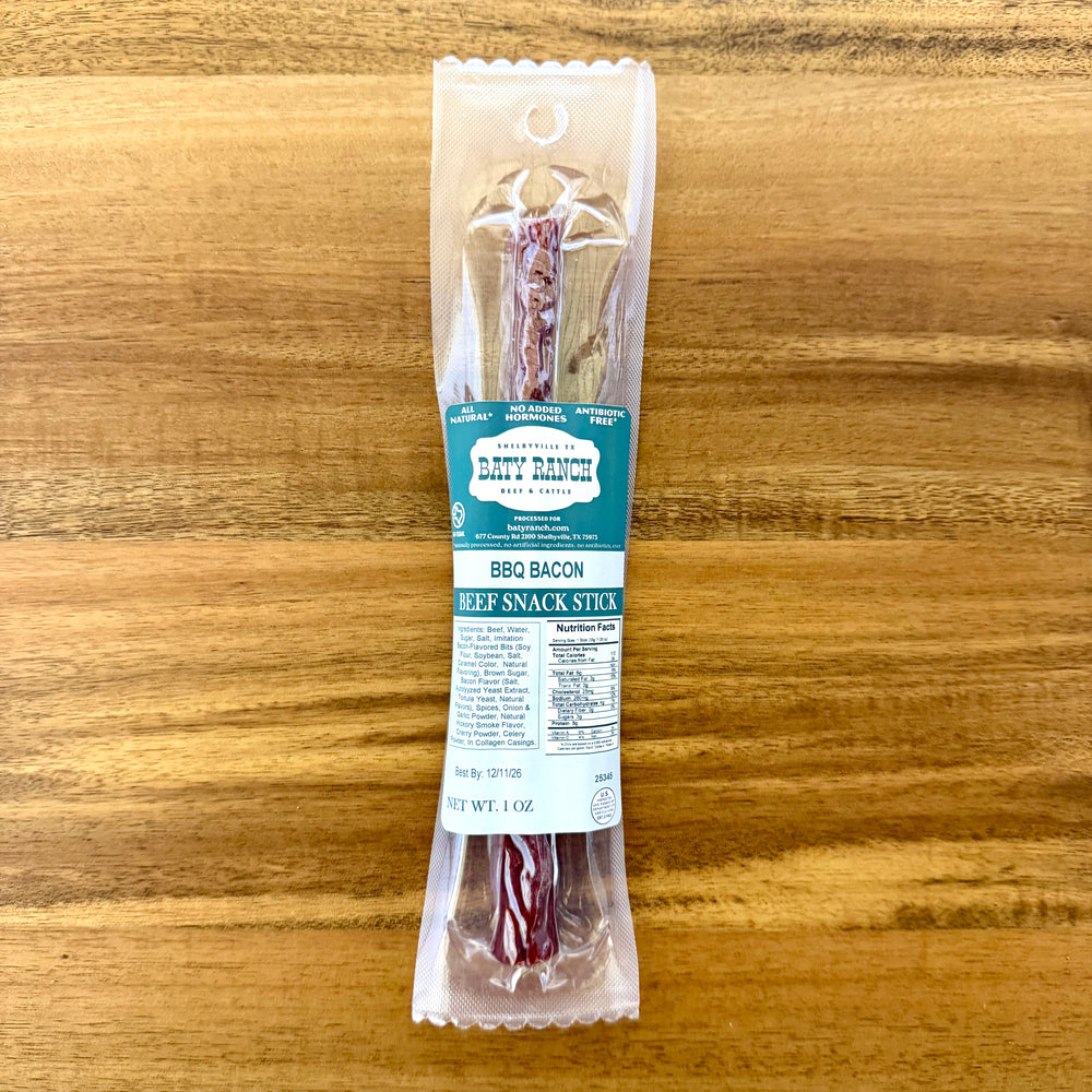 Packaged BBQ bacon snack stick on a wooden surface ready to eat