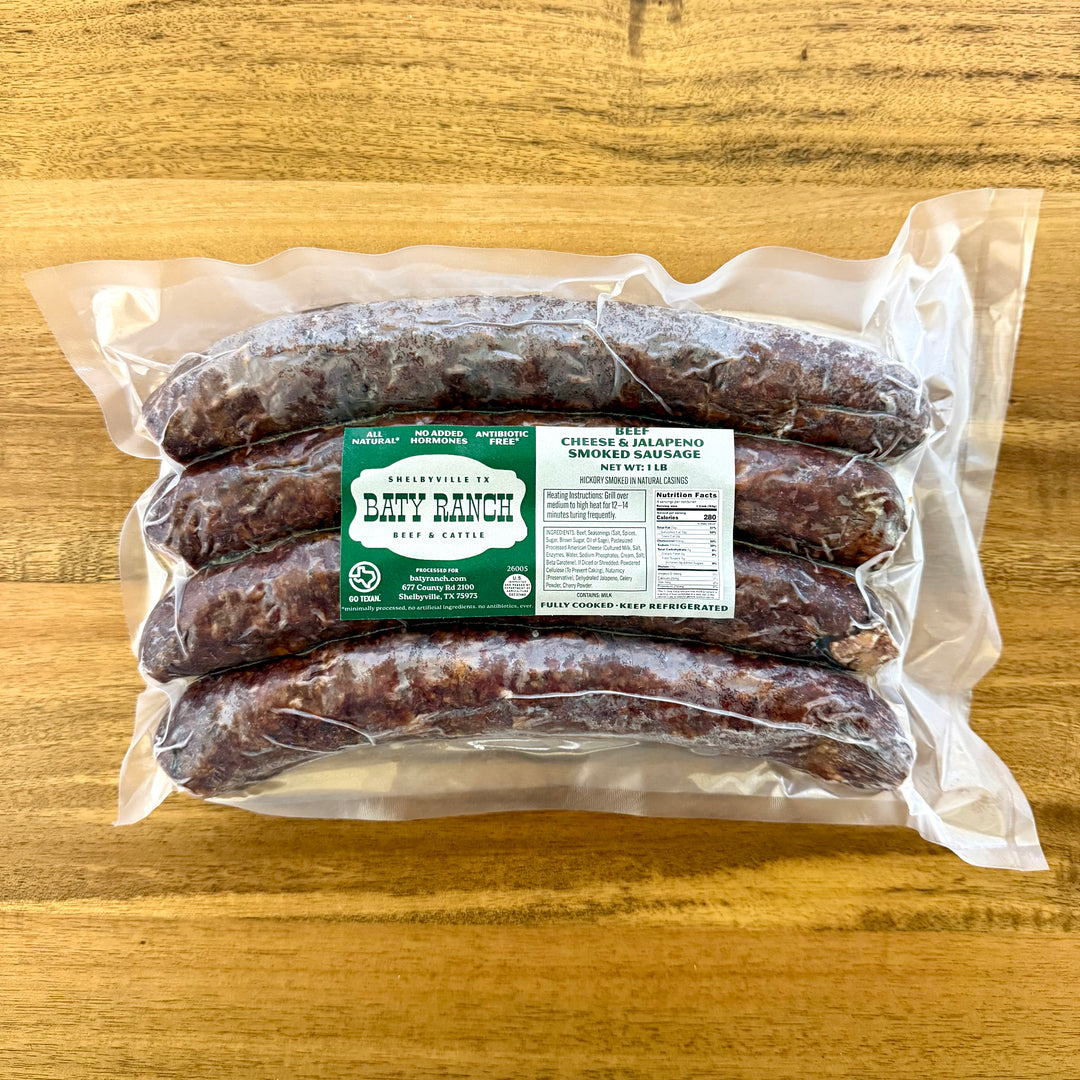 Packaged jalapeno & cheese sausages with a label on a wooden surface