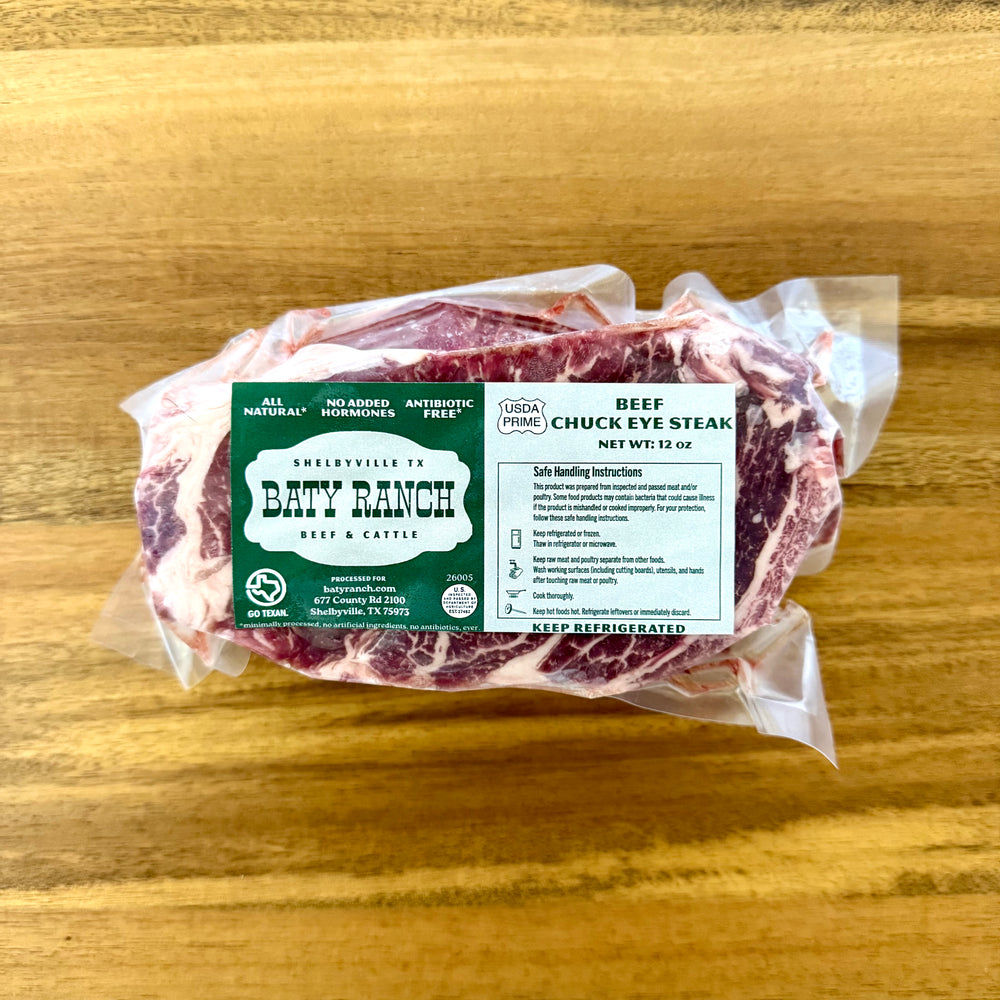 Packaged beef chuck eye steak with Dady Ranch label on a wooden surface