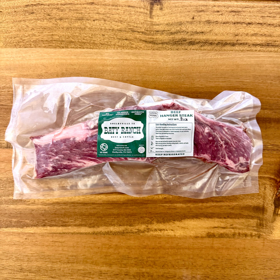 Packaged beef  hanger steak on a wooden surface with a label