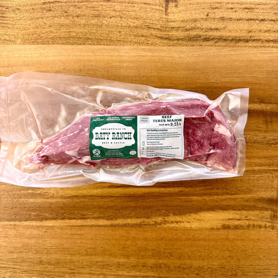 Packaged raw meat on a wooden surface with a Darty Ranch label.