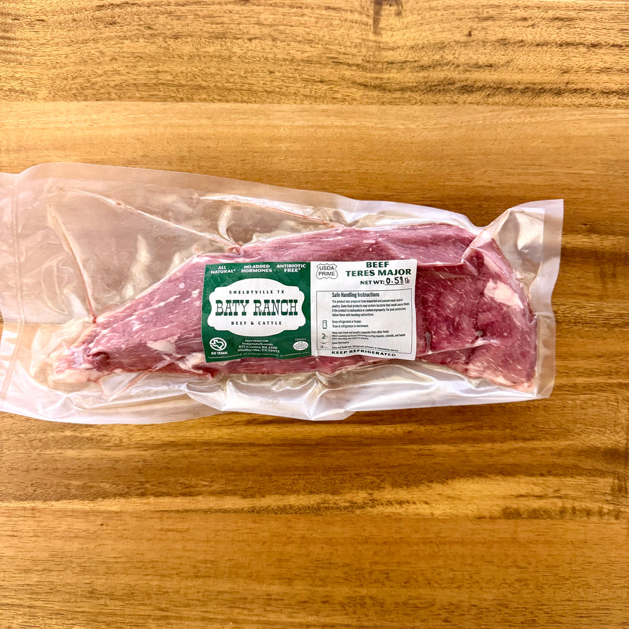 Packaged raw meat on a wooden surface with a Darty Ranch label.