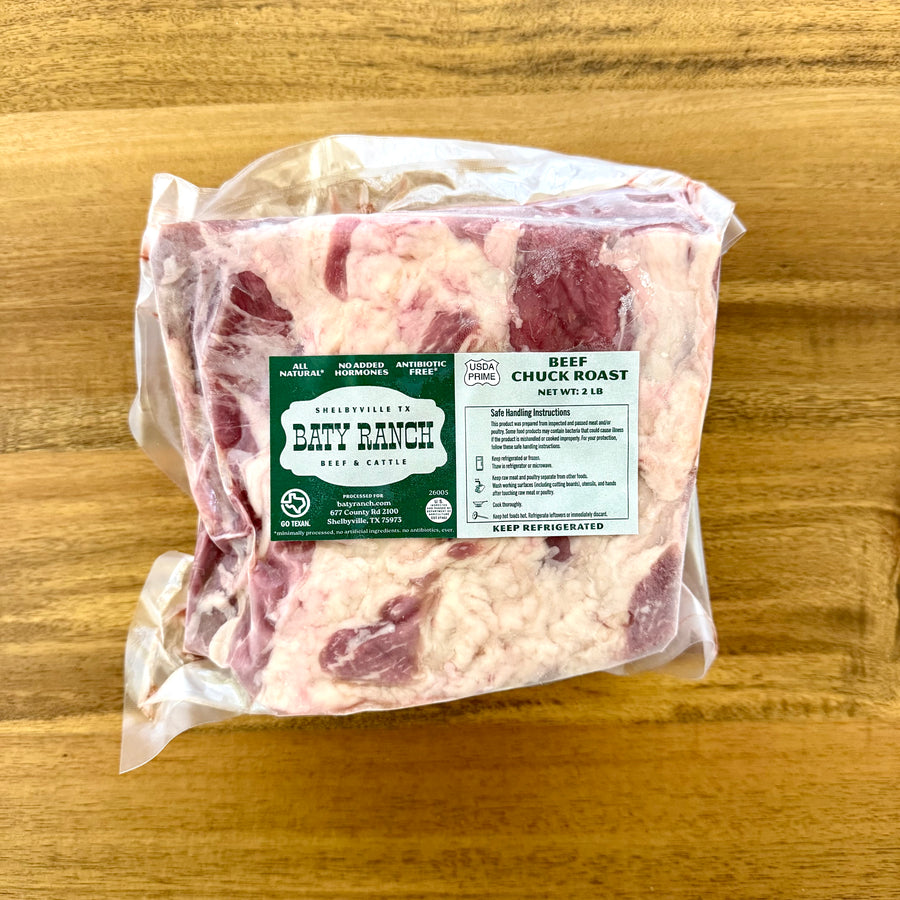Packaged beef chuck roast with a label on a wooden surface