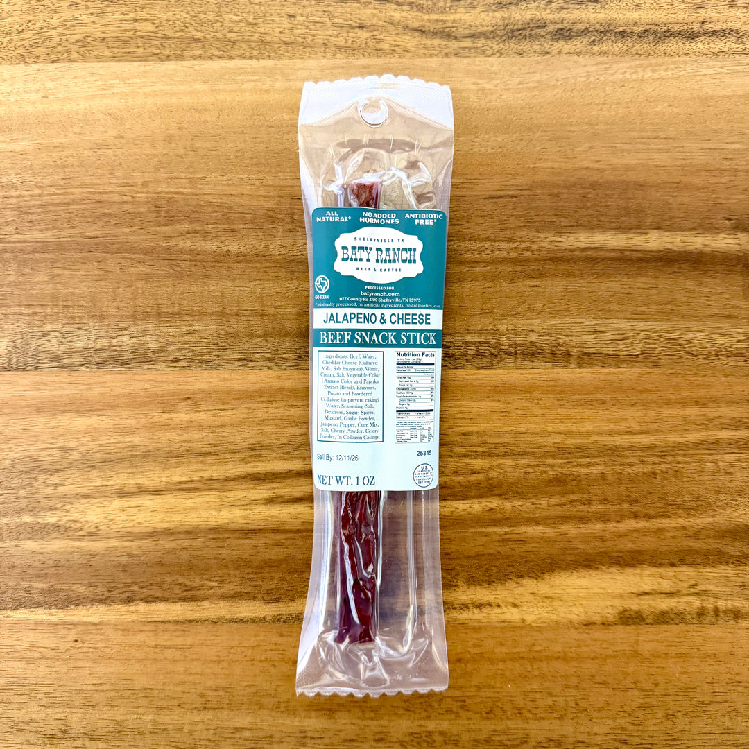 Packaged beef snack stick with label on a wooden surface ready to eat